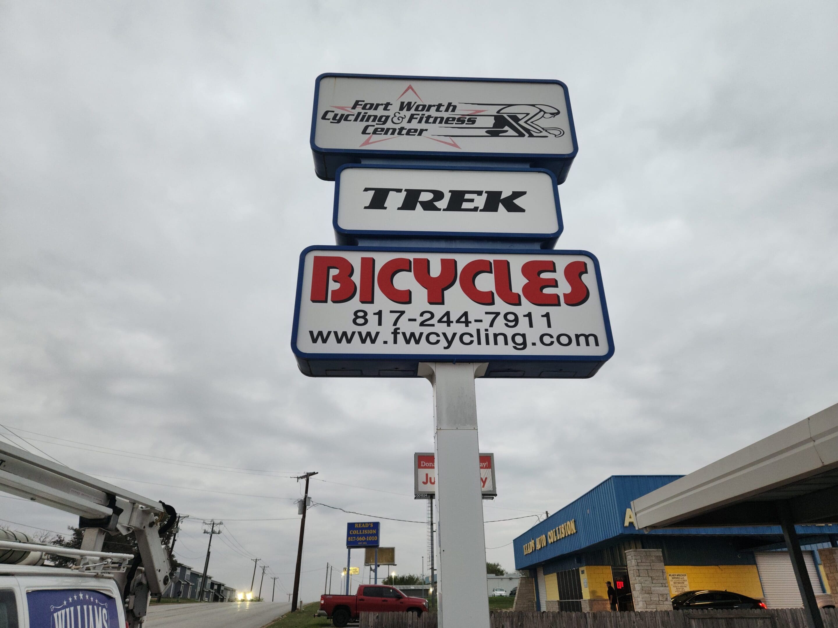 A sign for trek bicycles and red rock recycling.