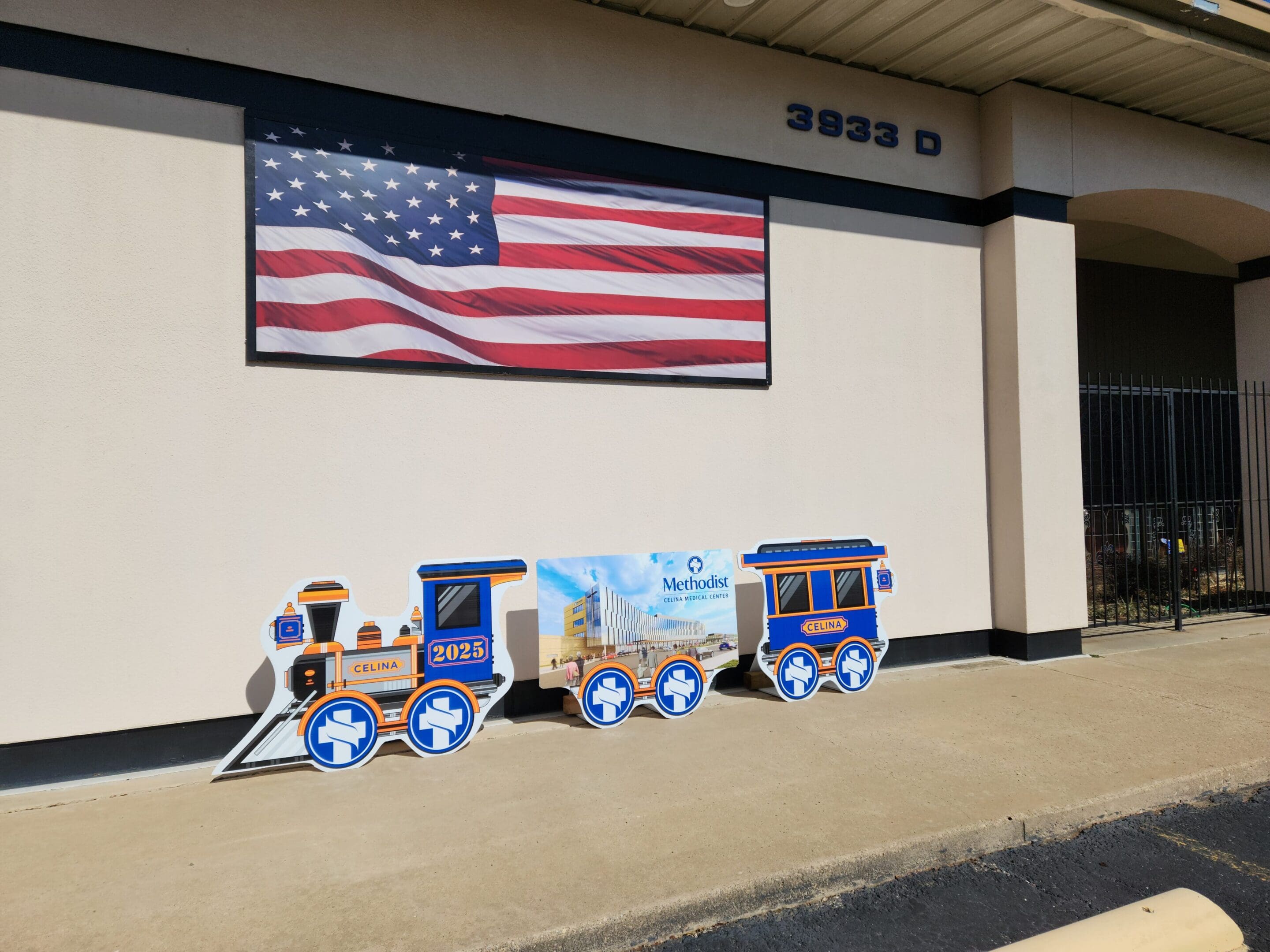 A train sitting in front of an american flag.