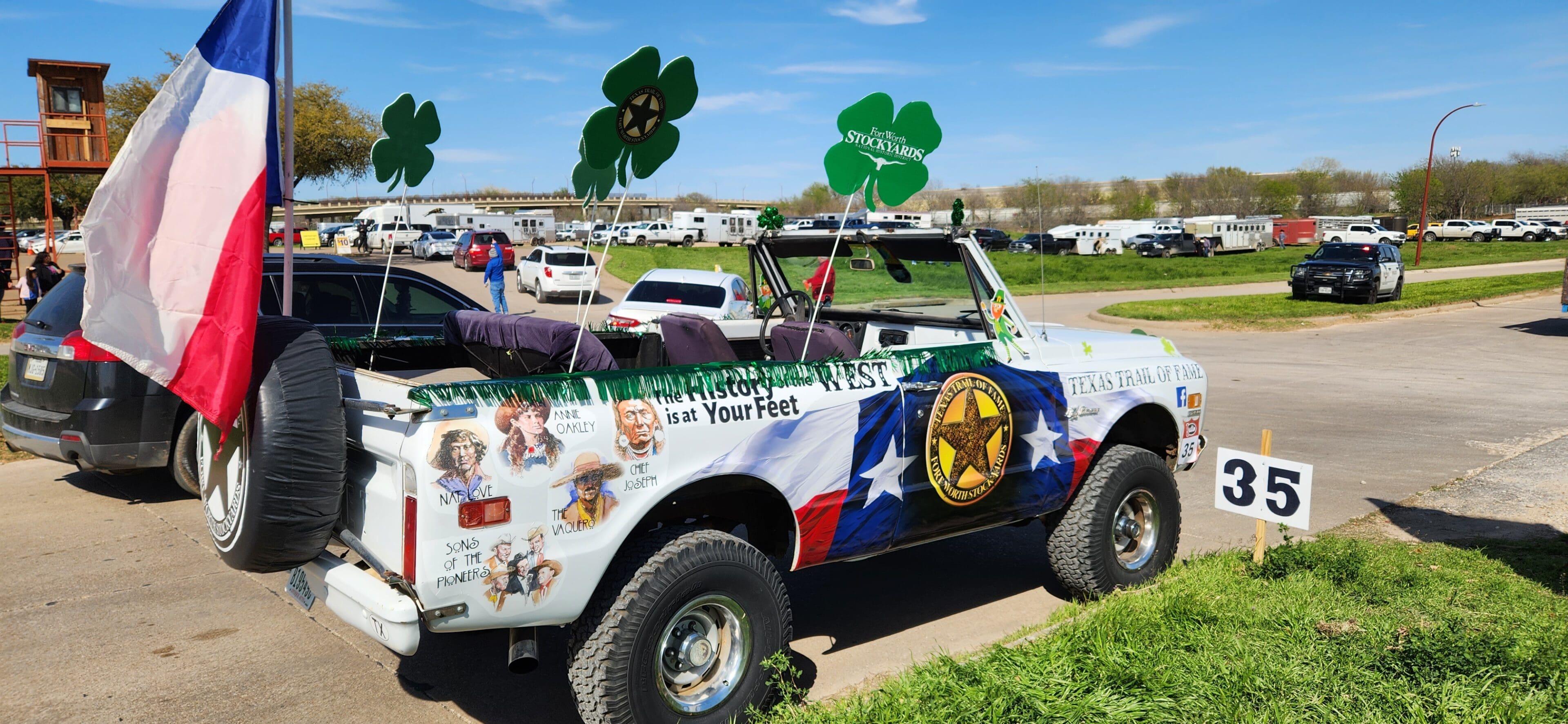 A truck with four leaf clover decorations on it.