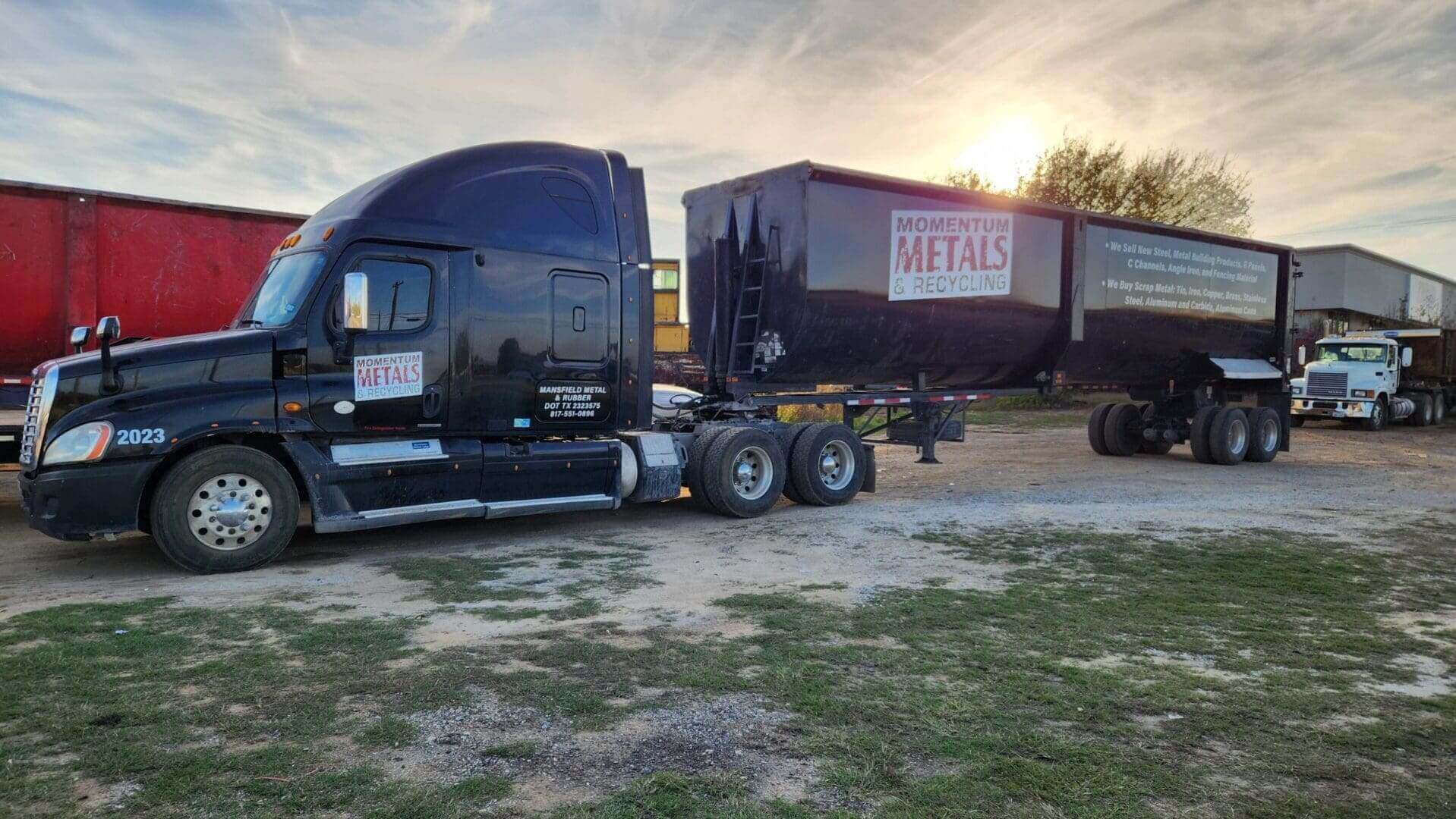 Truck with custom signs displayed outside commercial building lot.