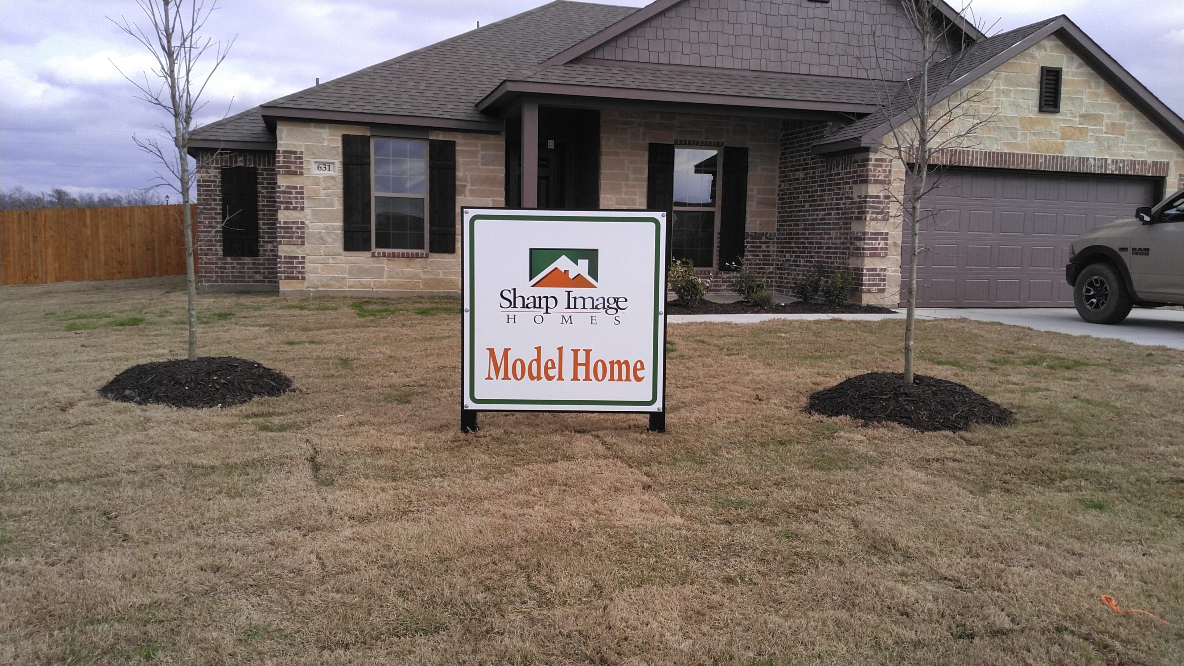 A sign in front of a house that says " model home ".