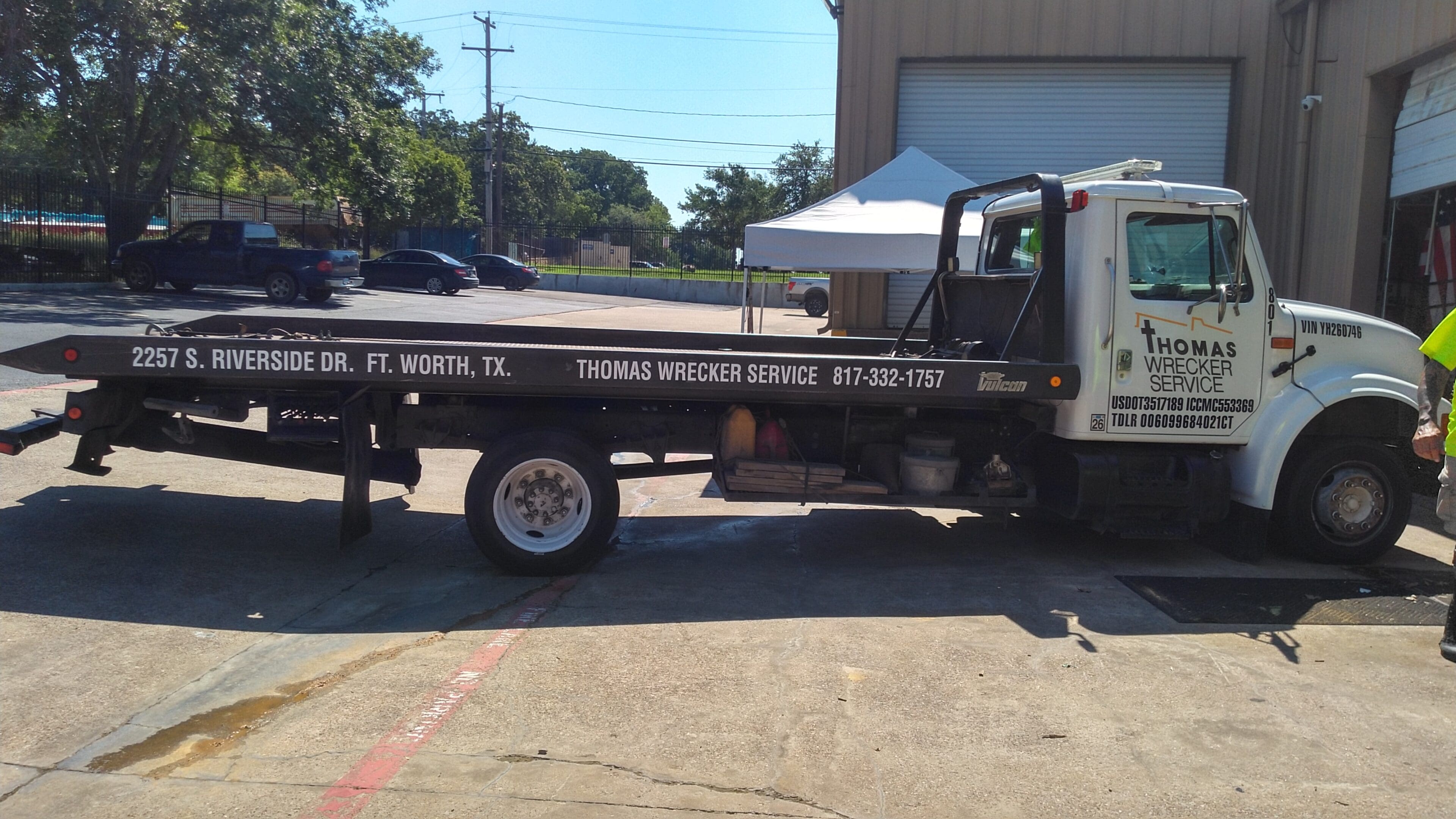 A tow truck parked in front of a building.