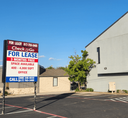 A for lease sign in front of a building.