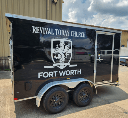 A black trailer with the words " revival today church fort worth ".