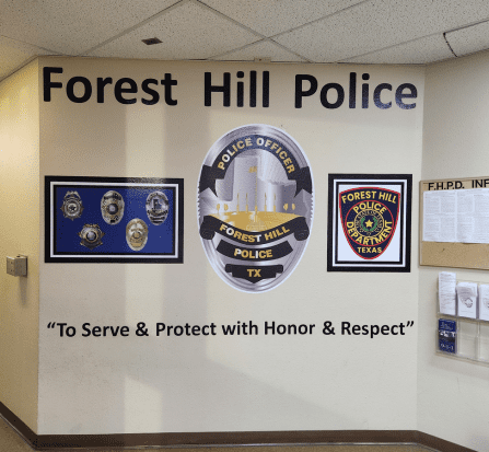 A wall with several police patches and badges on it.